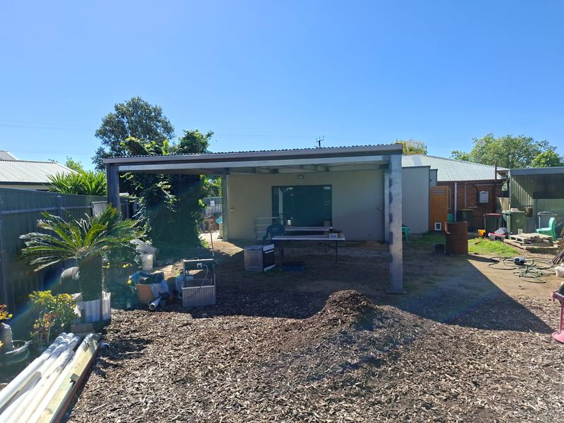 Newly built steel pergola with a corrugated roof, built by Iron Works
