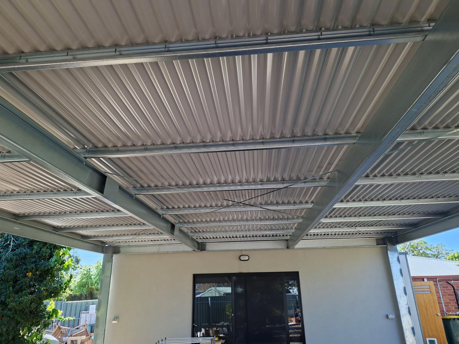Underside of the Tanunda pergola showing steel beams and purlins under the corrugated roof
